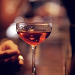 Glass of sparkling red wine on the bar's counter